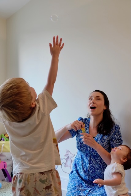 Bubbles Up!  Boy reaching for bubbles